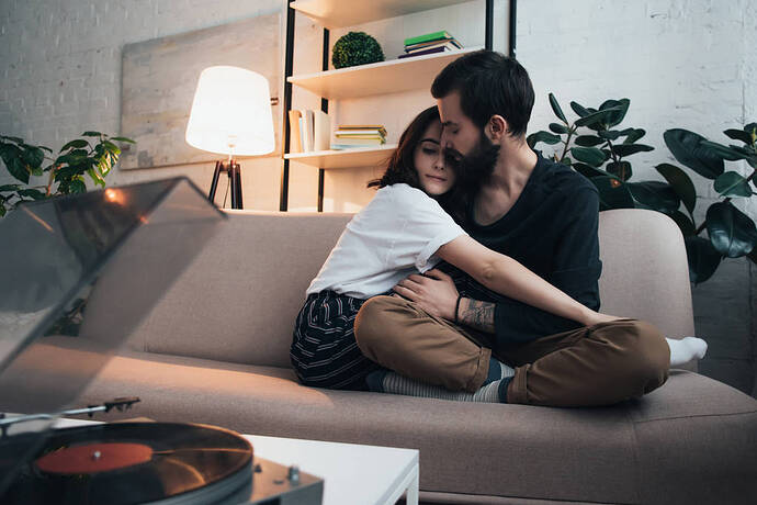 stock-photo-beautiful-young-couple-sitting-couch