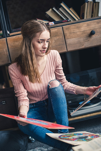 stock-photo-woman-looking-at-vinyl-records