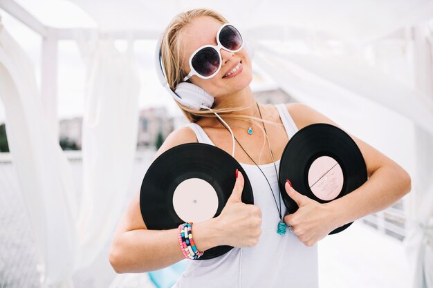 pretty-woman-with-vinyl-showing-thumbs-up_23-2147670577